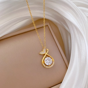 Detail of fishtail pendant necklace with large center zircon and pave diamond accents