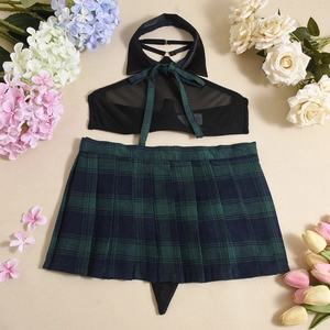 Detail of sheer black halter top with green tie and plaid pleated skirt on floral background