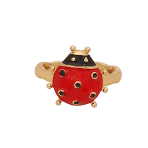 Cute red ladybug ring with golden band and enamel finish on white background
