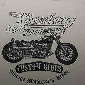 Detail of vintage Speedway Motorcycle print with Custom Rides text on black t-shirt