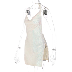 Macro detail of white sequin halter dress with iridescent finish and side slit feature