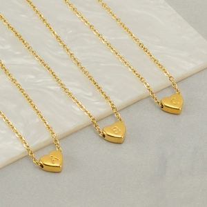 Golden heart pendant necklace with engraved letters A, B, and C on stainless steel