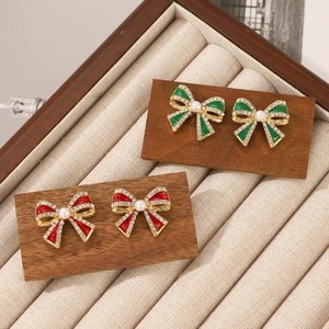 Detail of vintage bow earrings with pearls and rhinestones in red and green colors