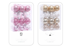 Detail of pink and champagne gold Christmas ball ornaments in clear plastic packaging