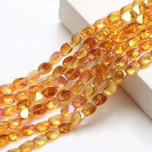 Macro shot of 10x12mm yellow AB crystal beads with faceted finish and rainbow luster