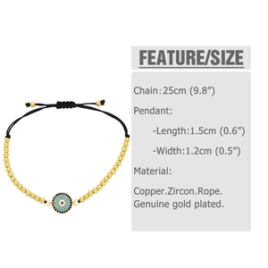 Macro shot of evil eye pendant with blue cubic zirconia and gold beaded bracelet