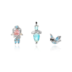 Macro shot of silver plated earrings with colorful zircon stones in cartoon animal shapes