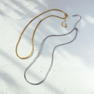 Flat snake bone chain necklace set in gold and silver plated stainless steel finishes