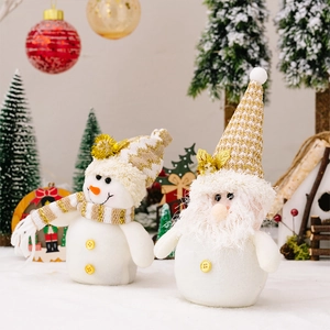 Detailed view of plush Christmas snowman and gnome dolls with golden festive accessories