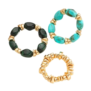 Detail of bohemian resin and irregular gold-colored CCB beaded bracelets set of three