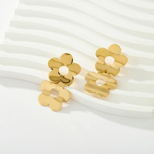 Close-up of dual hollow sunflower stud earrings in polished 18K gold-plated stainless steel