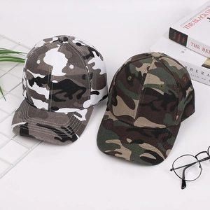 Classic camouflage baseball caps in grey and green, flat lay with modern accessories