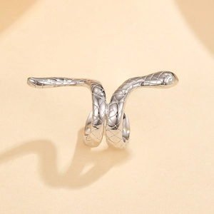 Macro detail of silver snake ring with scale texture and a white zircon eye