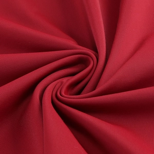 Macro shot of red knit fabric with vertical rib texture and high elasticity detail