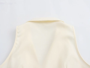 Close-up of the back collar and stitching details on a beige urban commute vest
