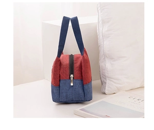 Close-up of red and blue contrast bento bag with durable zipper and woven handle