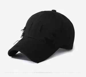 Close-up of black cotton twill baseball cap with distressed details and side tag