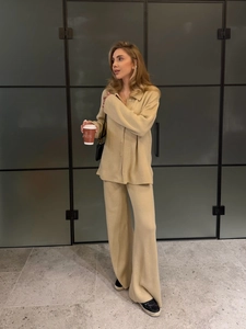Elegant beige knitted two-piece set featuring V-neck buttoned top and high waist trousers