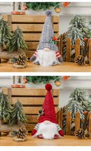Close-up of lighted Christmas gnome plush with knitted hats in grey and red festive colors