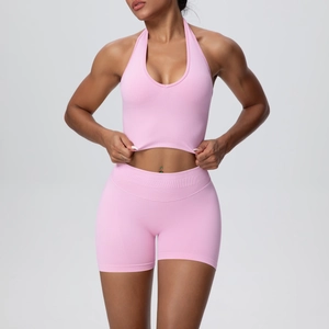 Close-up of pink seamless yoga set featuring halter neck top and high-waist sports shorts
