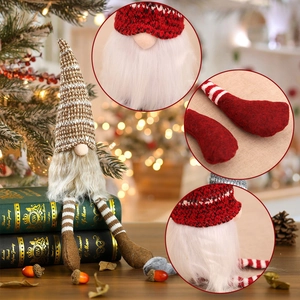 Christmas gnome doll with brown striped knit hat and long dangling legs on holiday background