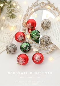 Detailed view of red and green Christmas balls with snowflake and reindeer patterns