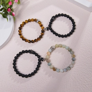 Couples magnetic bracelets featuring tiger eye and matte black beads with crown charm