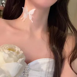 Detailed view of white translucent butterfly choker with sparkling diamond accents