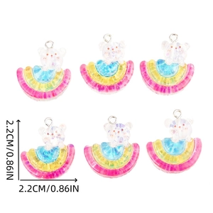 Close-up of rainbow resin bear charms for DIY jewelry with size measurement guides