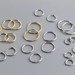 Various sizes of polished S925 sterling silver hoop earrings in gold and silver finishes