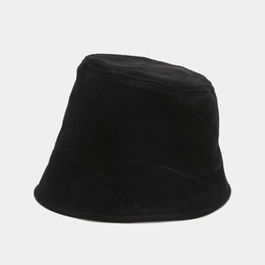 Close-up of matte twill texture on a minimalist black bucket hat for winter fashion