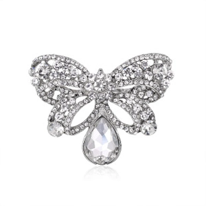 Close-up of silver bow brooch with sparkling crystals and a large teardrop pendant