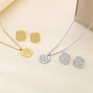 Close-up of 18K gold and silver plated square pendant necklaces and matching stud earrings