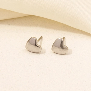 Macro shot of polished silver heart stud earrings made of durable 304 stainless steel