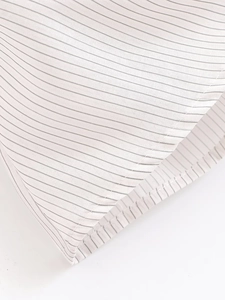 Macro detail of high-quality white pinstripe fabric with precise stitching on the hemline