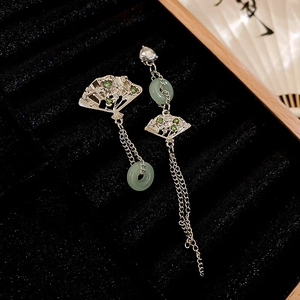 Detail view of silver fan-shaped earrings with bamboo nodes and long chain tassels