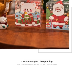 Detailed view of clear Christmas gift box with cartoon Santa and polar bear prints