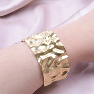 Polished 18k gold plated stainless steel cuff bracelet with irregular crumpled metal texture