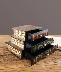 Close-up of European retro book-shaped drawer storage box with gold-stamped scroll patterns