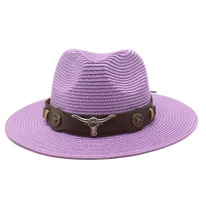 Detail of purple woven cowboy hat featuring a silver bull head buckle on a brown leather band