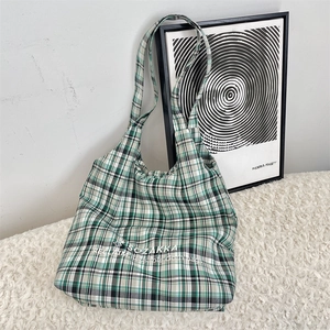 Detail of green and black plaid tote bag made of eco-friendly canvas fabric