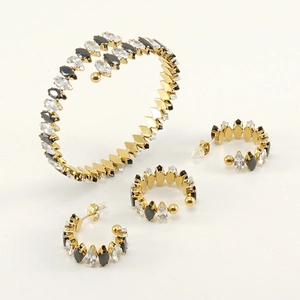 Detail of 18K gold-plated jewelry set with marquise-cut black and clear crystals