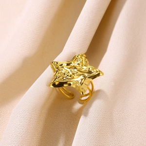 Macro shot of gold adjustable double-layer ring with textured starfish star surface