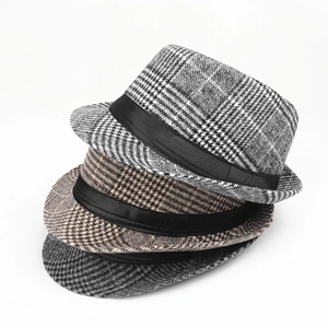 Detail of stacked vintage jazz hats showing houndstooth patterns and black satin ribbons