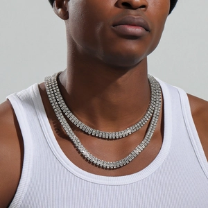 Close-up of double row silver tennis chain with rhinestones worn by a male model