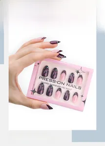 Detail of purple butterfly press-on nails with pink French tips in elegant packaging