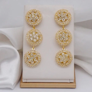 Elegant gold drop earrings with sparkling rhinestones in a geometric circular design
