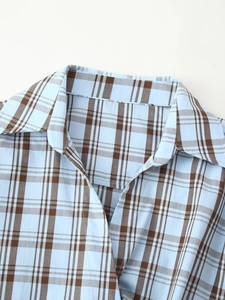 Detailed close-up of sharp pointed collar on blue and brown plaid poplin shirt