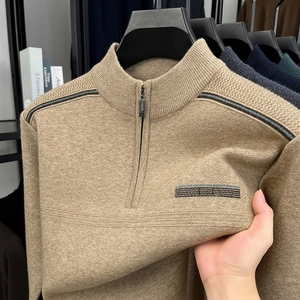 Detail of camel half-zip sweater showing high elastic knit texture and stripe accents