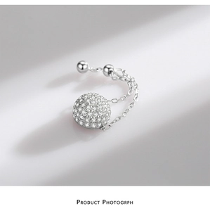 Macro shot of silver S925 chain ring with micro-paved sparkling zircon sphere charm